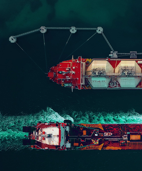 Aerial view of LNG tankers on the ocean.