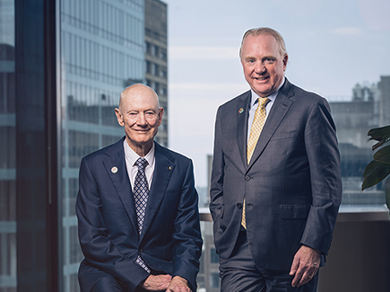 John Grill and Chris Ashton, leaders of Worley standing together in an office.