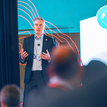 Andy Hemingway, Executive Group Director, Growth, speaking on stage.